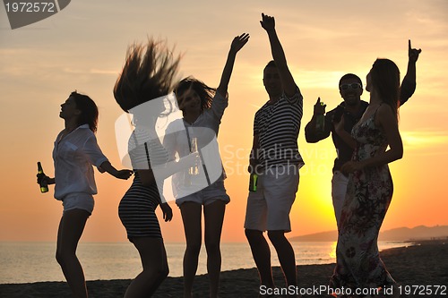 Image of Group of young people enjoy summer  party at the beach