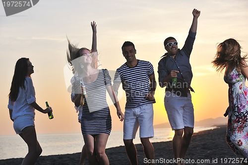 Image of Group of young people enjoy summer  party at the beach