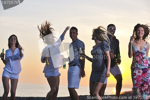 Image of Group of young people enjoy summer  party at the beach