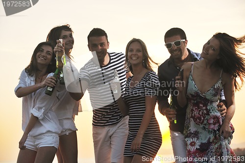 Image of Group of young people enjoy summer  party at the beach