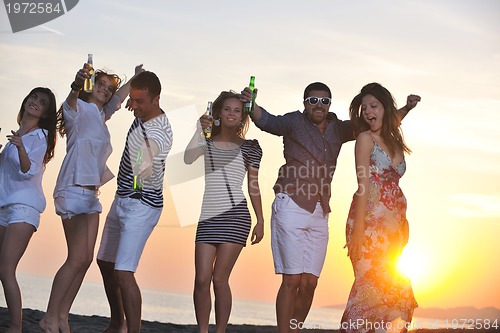 Image of Group of young people enjoy summer  party at the beach