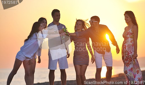 Image of Group of young people enjoy summer  party at the beach