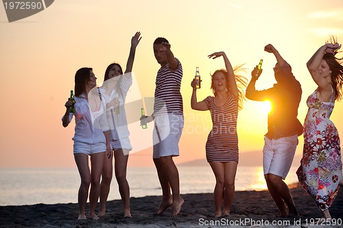 Image of Group of young people enjoy summer  party at the beach