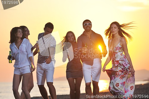 Image of Group of young people enjoy summer  party at the beach