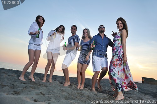 Image of Group of young people enjoy summer  party at the beach