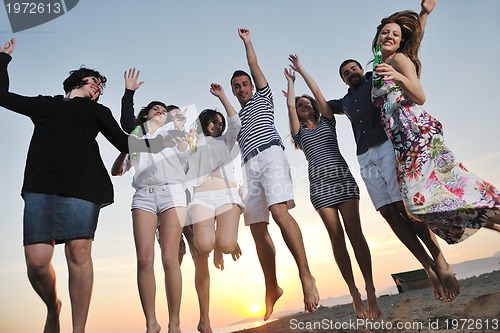 Image of Group of young people enjoy summer  party at the beach