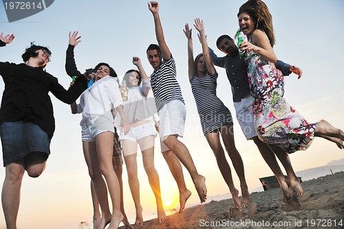 Image of Group of young people enjoy summer  party at the beach