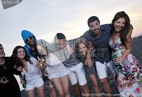 Image of Group of young people enjoy summer  party at the beach