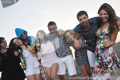 Image of Group of young people enjoy summer  party at the beach