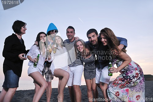 Image of Group of young people enjoy summer  party at the beach