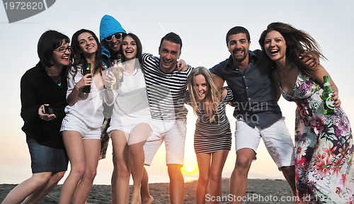 Image of Group of young people enjoy summer  party at the beach