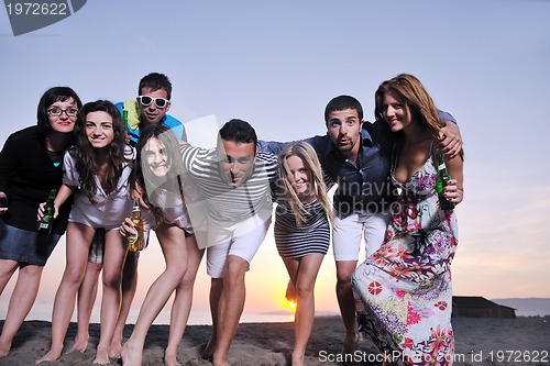 Image of Group of young people enjoy summer  party at the beach