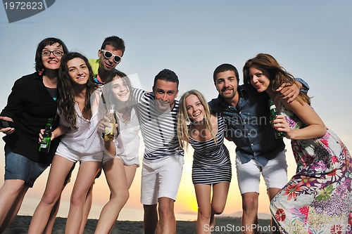 Image of Group of young people enjoy summer  party at the beach