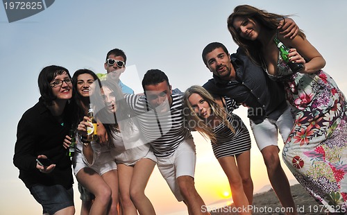 Image of Group of young people enjoy summer  party at the beach