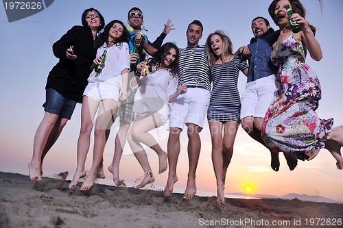 Image of Group of young people enjoy summer  party at the beach