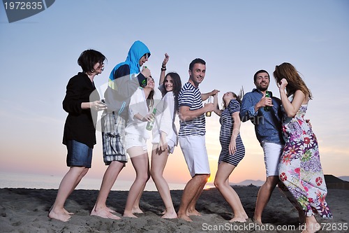 Image of Group of young people enjoy summer  party at the beach