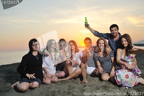 Image of Group of young people enjoy summer  party at the beach