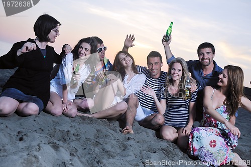 Image of Group of young people enjoy summer  party at the beach