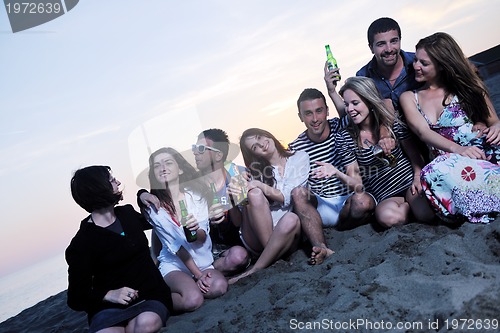 Image of Group of young people enjoy summer  party at the beach