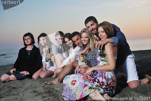 Image of Group of young people enjoy summer  party at the beach