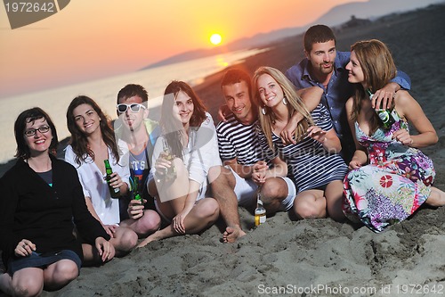 Image of Group of young people enjoy summer  party at the beach