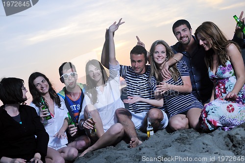 Image of Group of young people enjoy summer  party at the beach