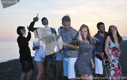 Image of Group of young people enjoy summer  party at the beach