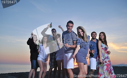 Image of Group of young people enjoy summer  party at the beach