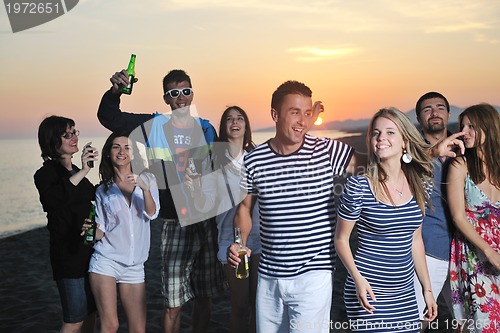 Image of Group of young people enjoy summer  party at the beach