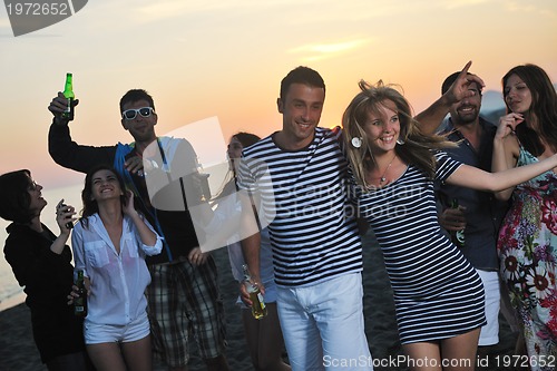 Image of Group of young people enjoy summer  party at the beach