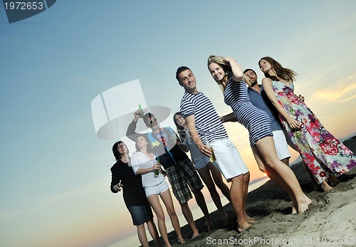 Image of Group of young people enjoy summer  party at the beach