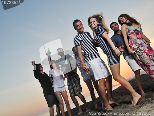 Image of Group of young people enjoy summer  party at the beach