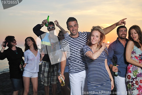 Image of Group of young people enjoy summer  party at the beach