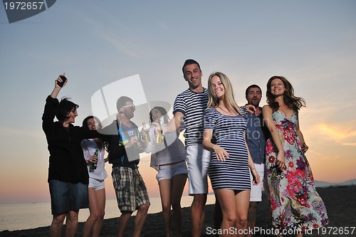 Image of Group of young people enjoy summer  party at the beach