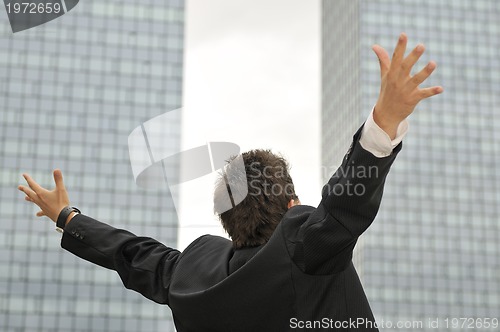 Image of Outdoor portrait of young and happy  businessman