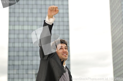 Image of Outdoor portrait of young and happy  businessman