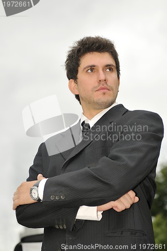 Image of Outdoor portrait of young and happy  businessman