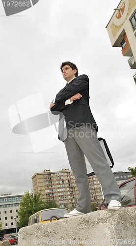 Image of Outdoor portrait of young and happy  businessman