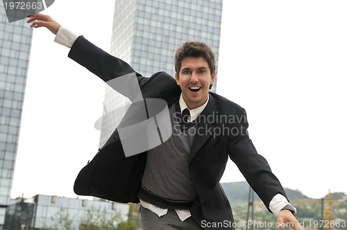 Image of Outdoor portrait of young and happy  businessman