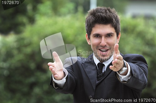 Image of Young caucasian business man in a suite, pointing at camera to y