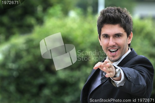 Image of Young caucasian business man in a suite, pointing at camera to y