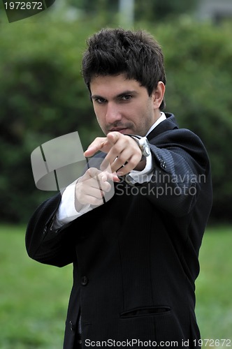 Image of Young caucasian business man in a suite, pointing at camera to y