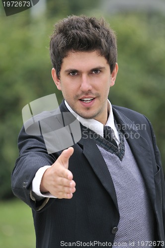 Image of Young caucasian business man in a suite, pointing at camera to y