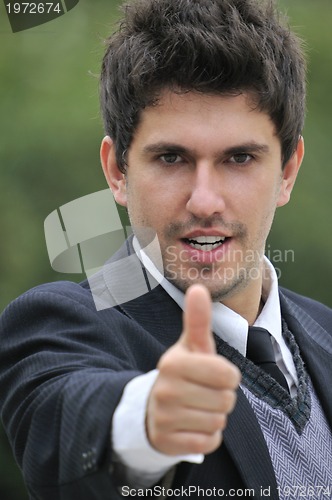 Image of Young caucasian business man in a suite, pointing at camera to y