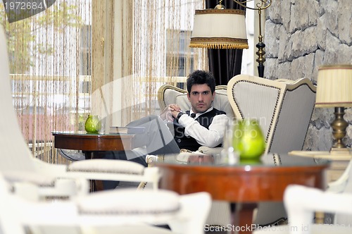 Image of indoor portrait of young and happy  businessman 