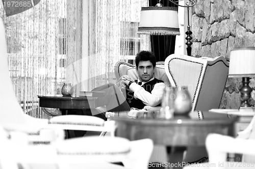 Image of indoor portrait of young and happy  businessman 