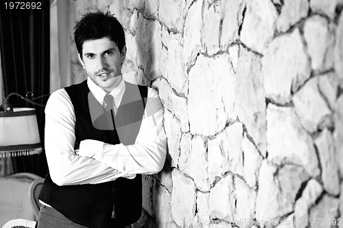 Image of indoor portrait of young and happy  businessman 