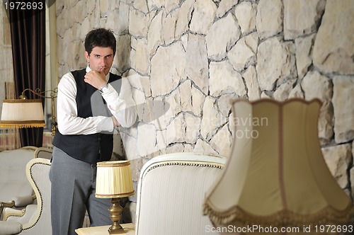 Image of Indoor portrait of young and happy  businessman
