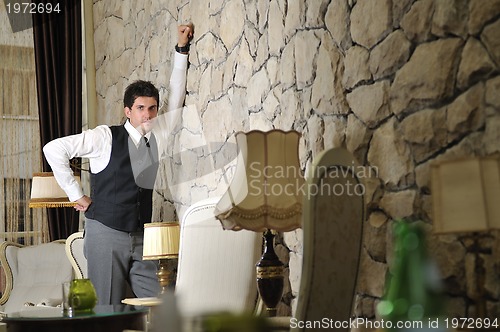 Image of Indoor portrait of young and happy  businessman