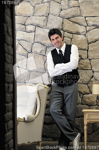 Image of indoor portrait of young and happy  businessman 